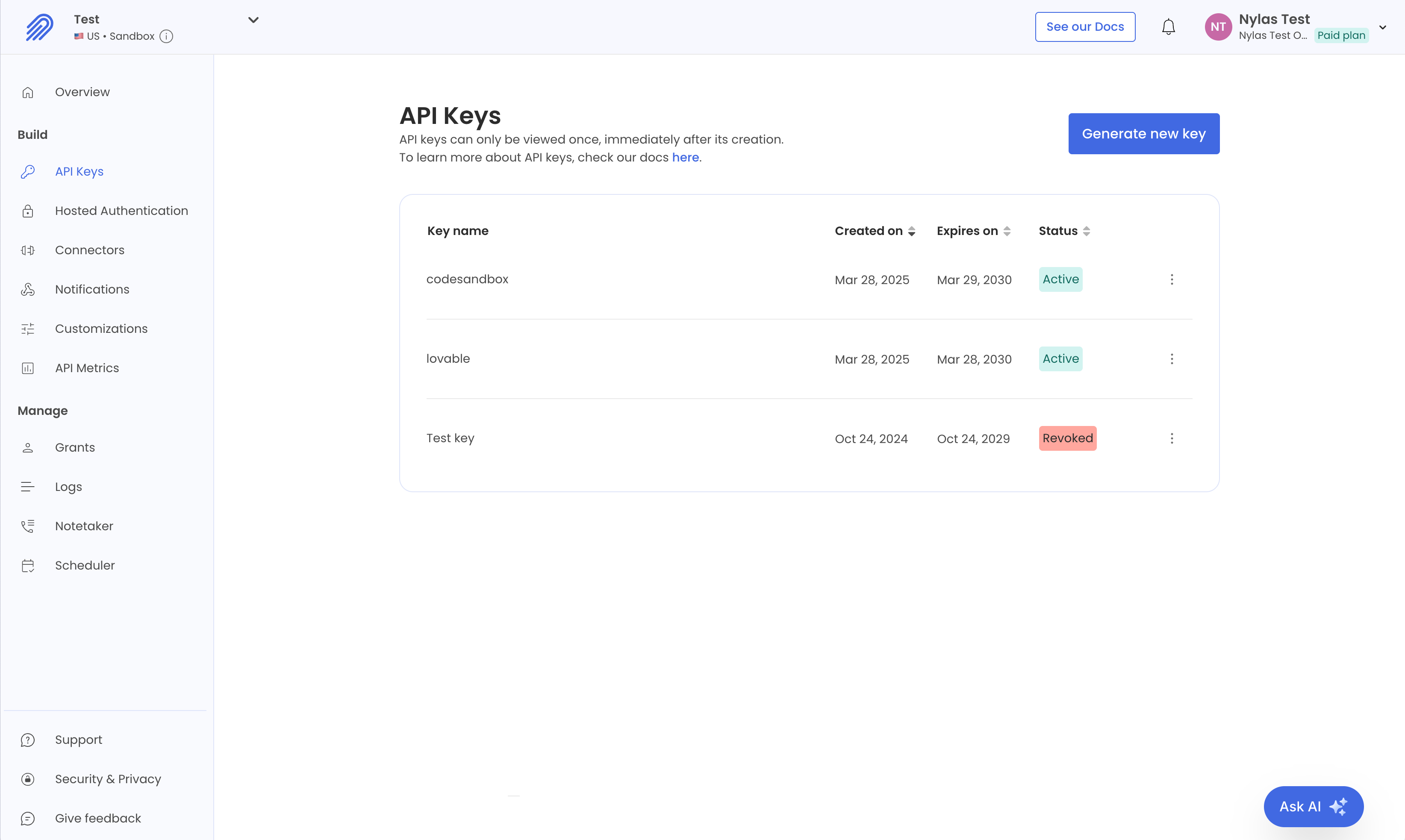 The Nylas Dashboard showing the API Keys page for a Development application. Three API keys are listed. Two are active, and one is revoked.